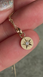 Video of 14k gold necklace featuring a hand-engraved star-set diamond charm on a curb chain