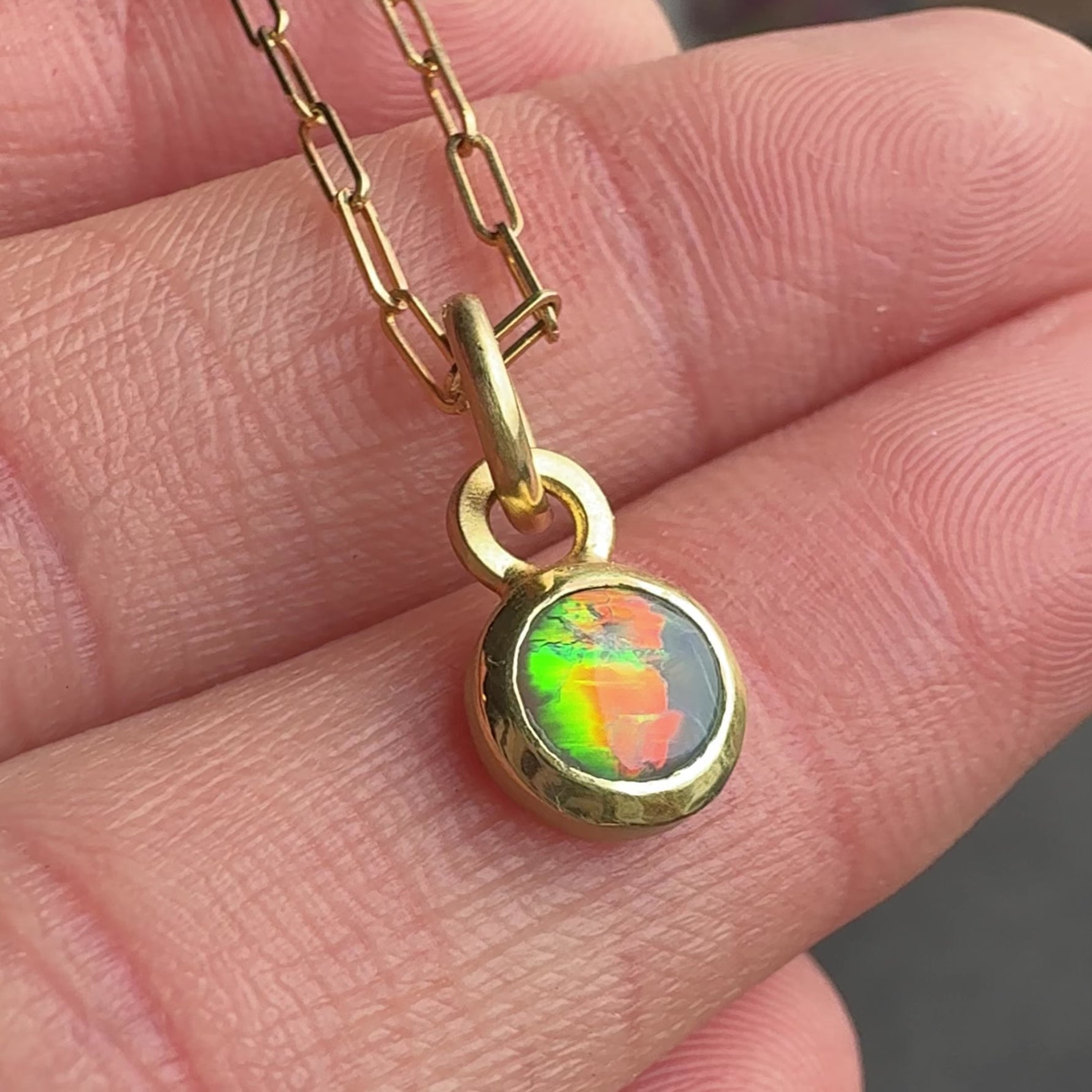 18k Yellow Gold Black Opal Engraved Necklace by Corkie Bolton Jewelry. Video shows neon flashes in the opal. Red, orange green and blue.