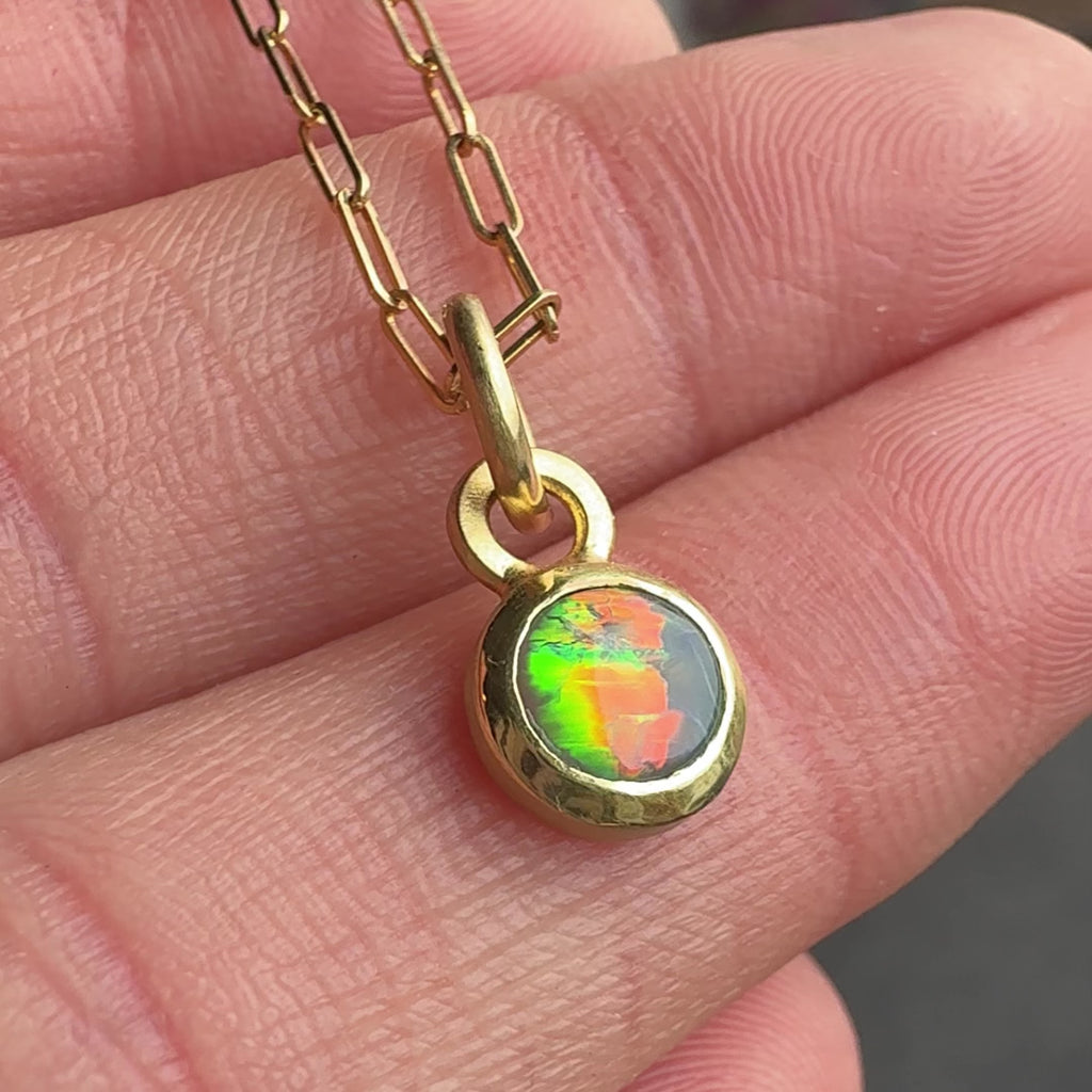 18k Yellow Gold Black Opal Engraved Necklace by Corkie Bolton Jewelry. Video shows neon flashes in the opal. Red, orange green and blue.