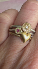 Side-by-side comparison of the Puffy Heart Ring with other ring styles for scale reference.