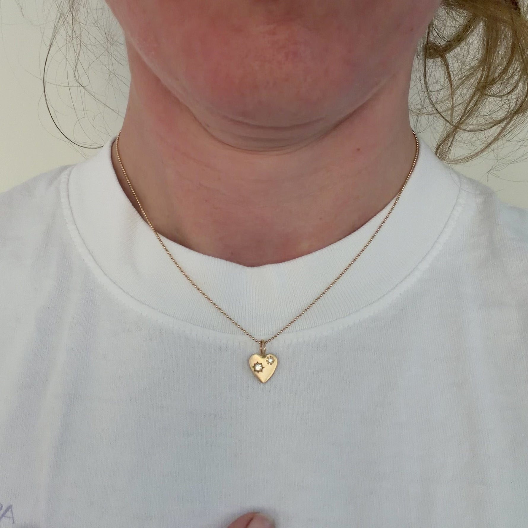 Video details of the Misfit diamond 14k yellow gold necklace on Corkie Bolton, the jeweler.