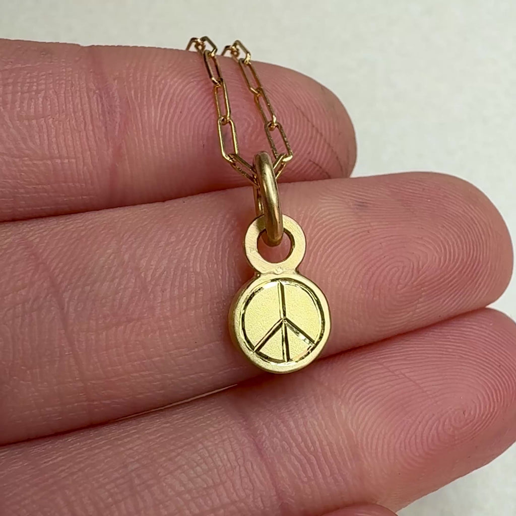 Backside of Peace 18K Opal Necklace, showing it's hand engraved peace sign.