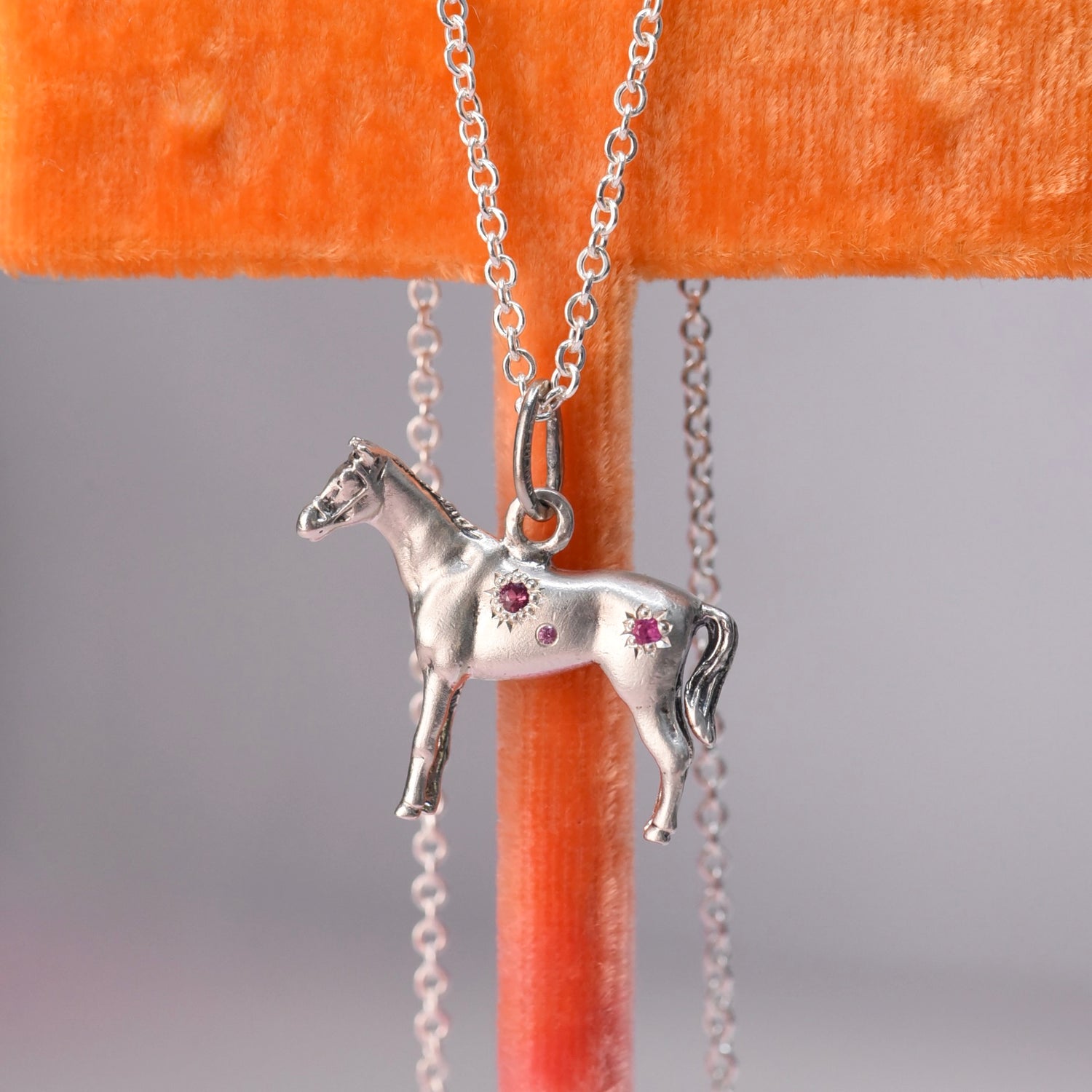 Vintage Silver Horse Charm engraved with pinbk sapphires.
