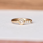 Handcrafted 14k yellow gold ring featuring a 4mm ice rose cut salt and pepper diamond, responsibly sourced from Misfit Diamonds. The band is hand-engraved with tapered diamond pavé on one side. Size 6.25.