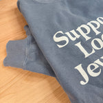 Support Local Jewelers sweatshirt in Blue Jean — a faded denim-blue garment-dyed unisex crewneck with a soft, lived-in feel, by Corkie Bolton Jewelry. Sleeve details.