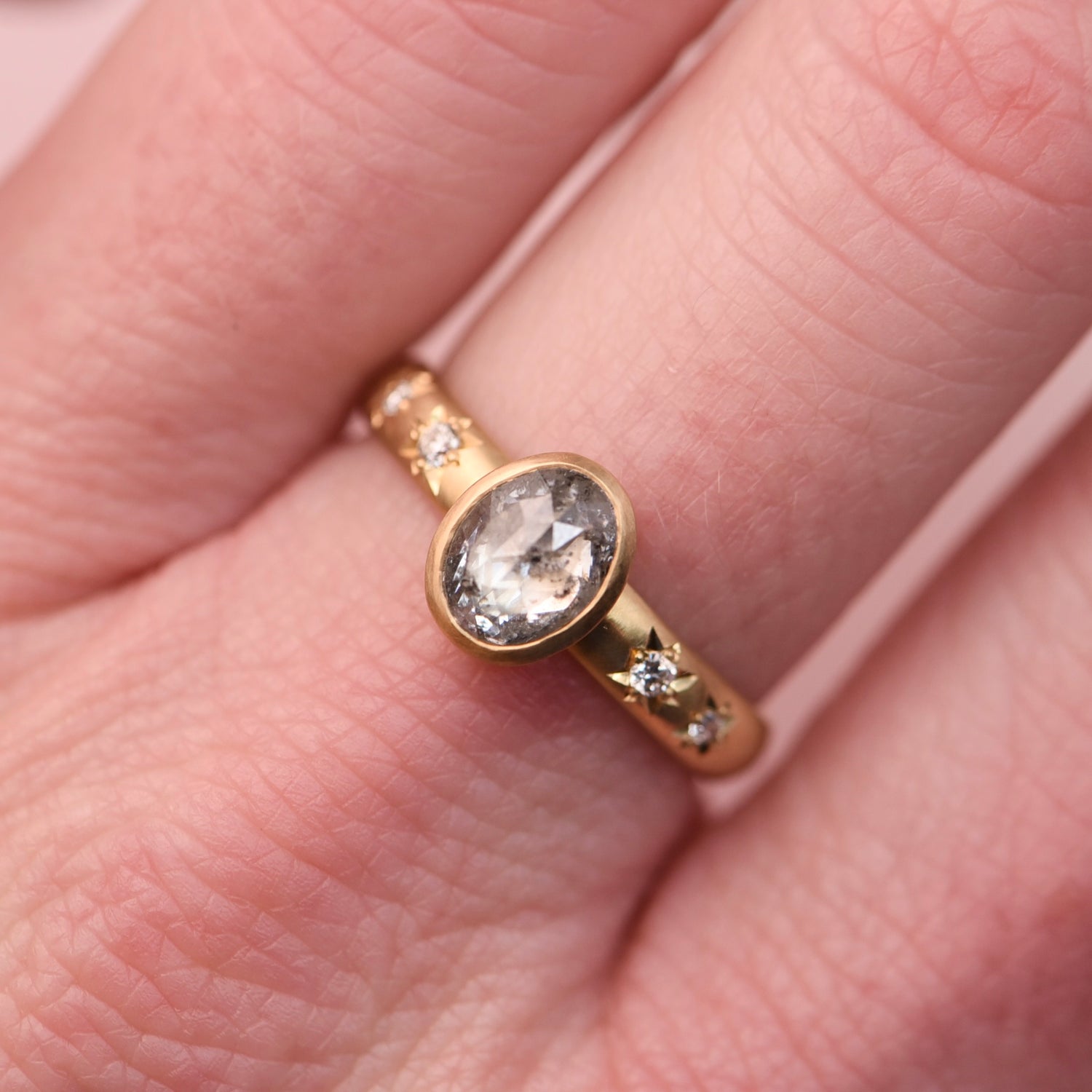 One-of-a-kind 18k yellow gold salt and pepper diamond engagement ring shown on hand