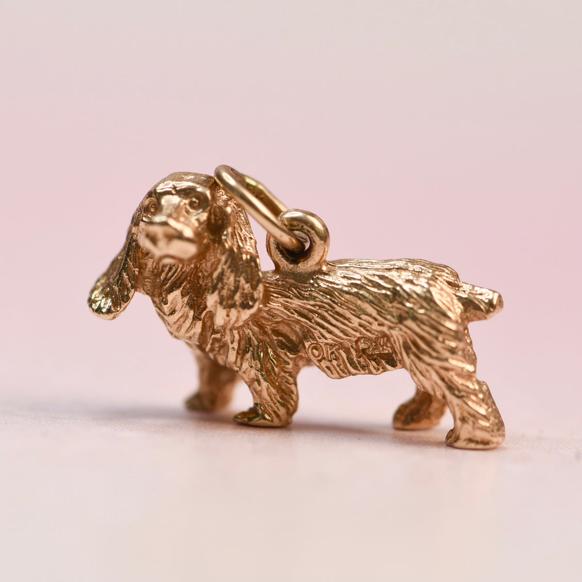 Vintage 14k yellow gold three-dimensional cocker spaniel charm before restoration, shown without the beret or diamond eyes
