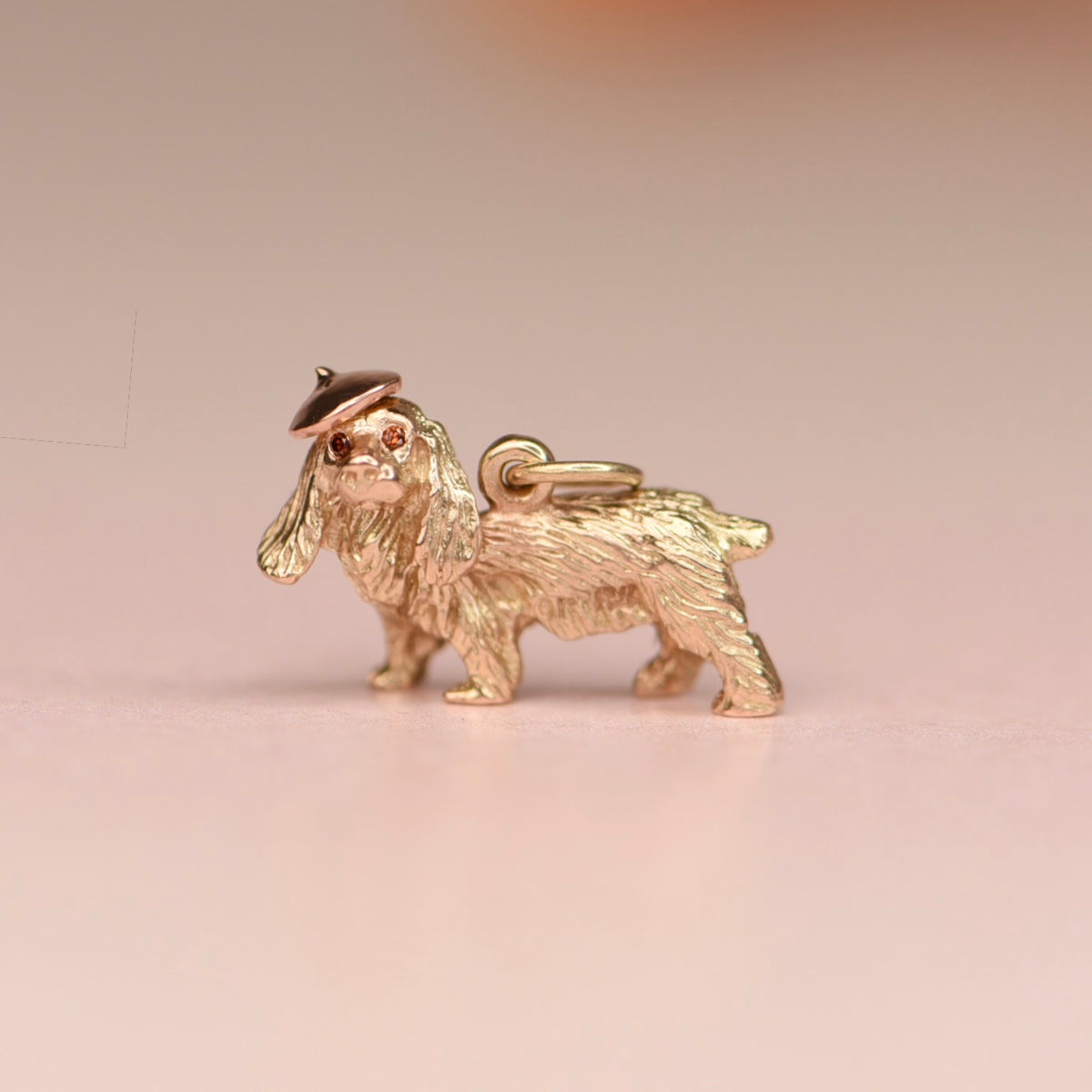 Vintage 14k yellow gold three-dimensional cocker spaniel charm with a hand fabricated rose gold beret and burnt orange diamond eyes