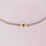 Close-up of the Vintage Curb Chain + 14k Sapphire Charm Bracelet by Corkie Bolton Jewelry, showing the blue sapphire cabochon set in a hand-engraved 14k gold star charm on a reclaimed silver curb chain.