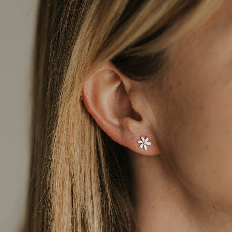 Silver flower stud earring with six petals.