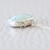Sterling silver and Sand Hill Turquoise necklace featuring a tiny hand fabricated flower.